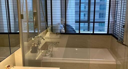 Modern bathroom with glass-enclosed bathtub