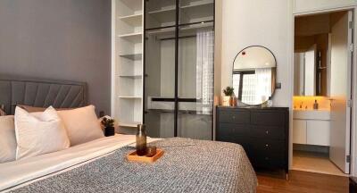 Modern bedroom with queen-sized bed, bedside storage, and en-suite bathroom