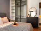 Modern bedroom with queen-sized bed, bedside storage, and en-suite bathroom