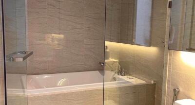 Modern bathroom with glass partition and bathtub