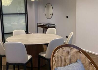 Modern dining area with a round table and six chairs