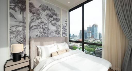 Modern bedroom with a large window offering a city view