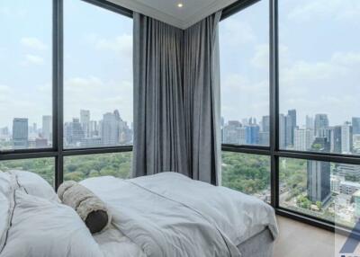 Modern bedroom with large windows and city view