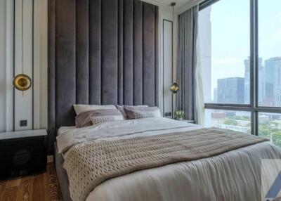 Modern bedroom with large window and city view