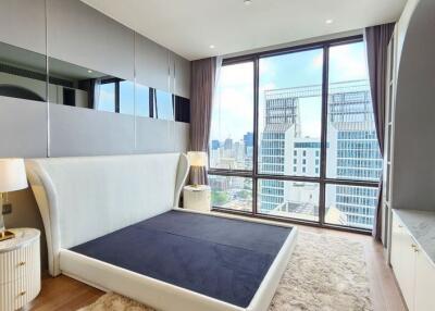 Luxurious bedroom with a large window and city view