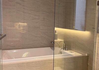 Modern bathroom with bathtub and glass partitions