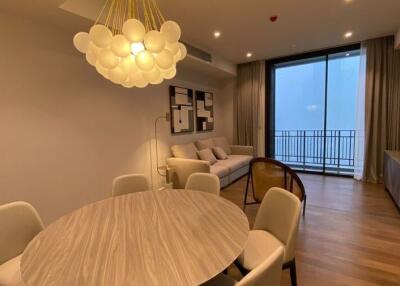 Modern living room with dining area and balcony view