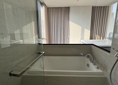 Modern bathroom with large bathtub and glass shower enclosure