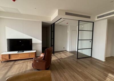 Modern living room with wooden flooring, TV, and glass partition wall