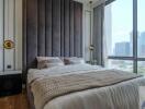 Modern bedroom with a large bed and city view