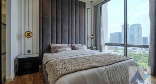 Modern bedroom with a large bed and city view