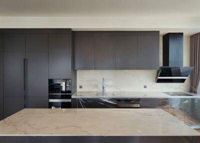 Modern kitchen with marble countertop and built-in appliances