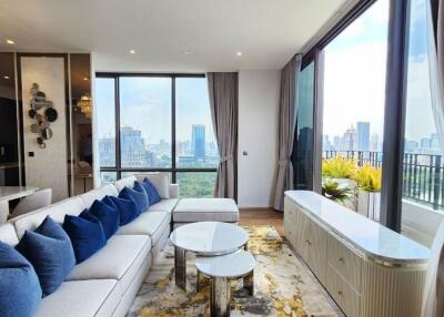 Spacious living room with a city view, modern furniture, and decor