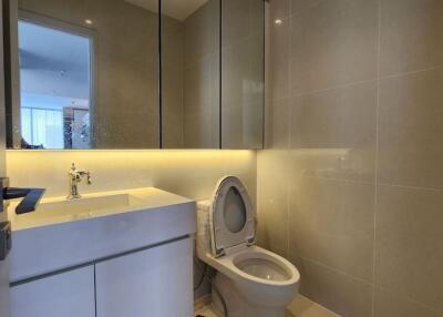 A modern bathroom with a toilet and sink.