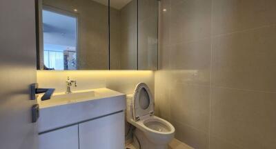 A modern bathroom with a toilet and sink.