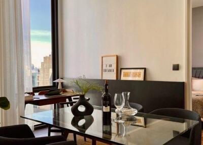 Modern living area with dining table and view of adjoining bedroom