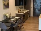 Modern kitchen and dining area with wood flooring