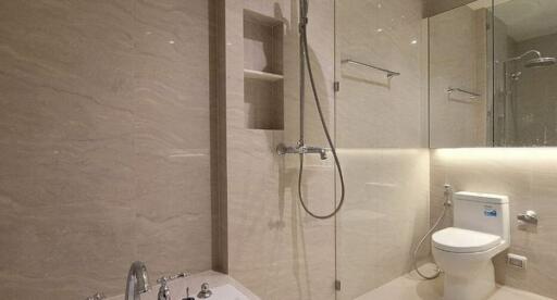 Modern bathroom with glass shower and beige tiles