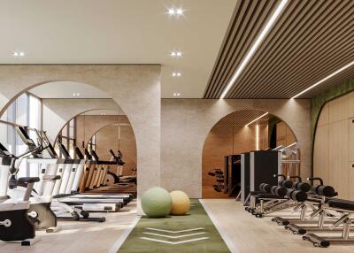 Modern gym with various exercise equipment and large windows.