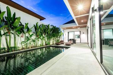 A luxury villa with a private swimming pool and modern outdoor lounge.