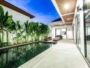 A luxury villa with a private swimming pool and modern outdoor lounge.