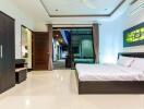 Modern bedroom with large bed, wardrobe, desk, and access to outdoor area