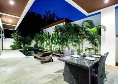 Modern outdoor area with swimming pool and dining setup