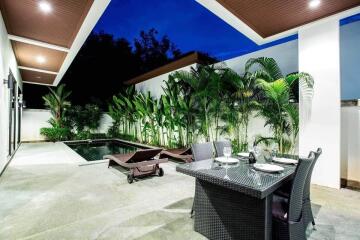 Modern outdoor area with swimming pool and dining setup