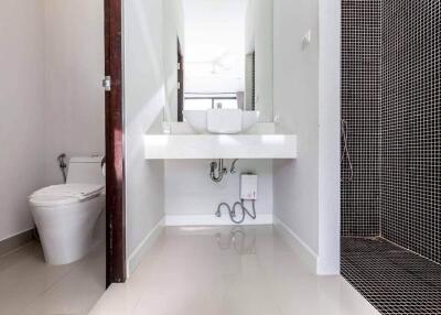 Modern clean bathroom with a sink, toilet, and shower