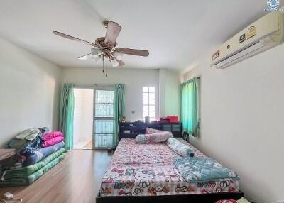 Brightly lit bedroom with ceiling fan, air conditioning, and large windows
