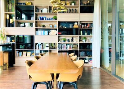 Modern dining room with wooden table and bookshelf