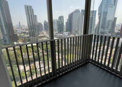 City view from balcony with floor-to-ceiling windows