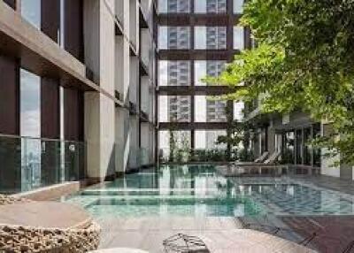 Outdoor communal swimming pool area in a high-rise building
