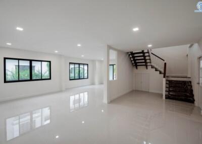Spacious and modern main living area with staircase and large windows