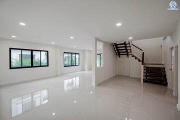 Spacious and modern main living area with staircase and large windows