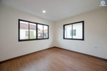 Bright and spacious empty bedroom with large windows