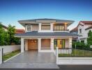 Modern two-story house exterior with garage and driveway