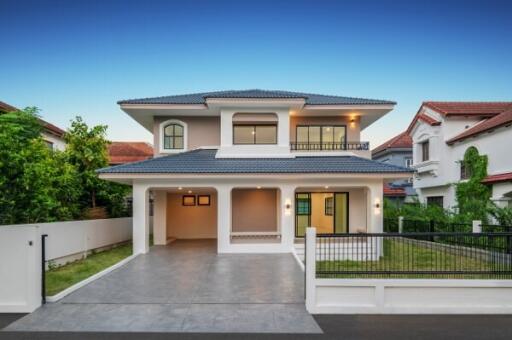 Modern two-story house exterior with garage and driveway