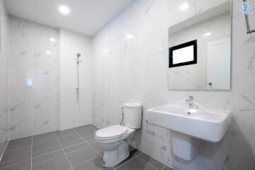 Modern bathroom with shower, toilet, and sink