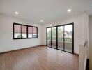 Spacious living room with large windows and sliding glass doors