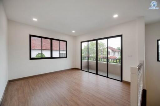 Spacious living room with large windows and sliding glass doors