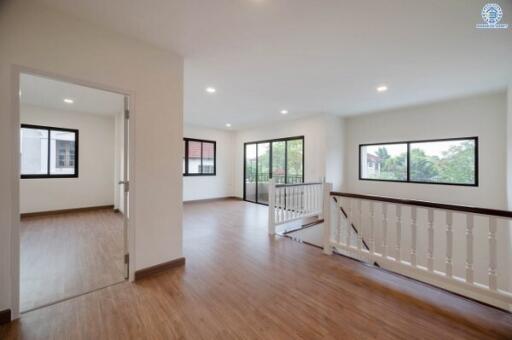 Spacious living area with natural light and wooden flooring