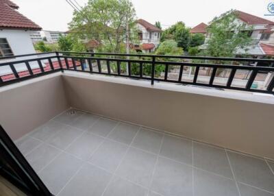 Spacious balcony with tiled flooring and a view of the neighborhood