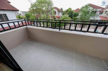 Spacious balcony with tiled flooring and a view of the neighborhood