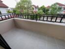 Spacious balcony with tiled flooring and a view of the neighborhood