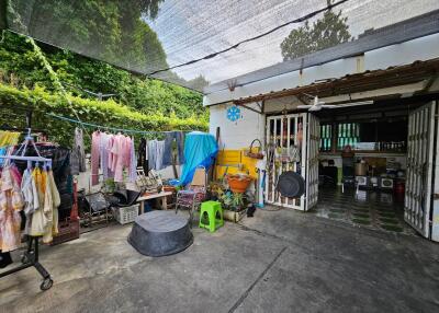 Covered outdoor area with laundry and various items
