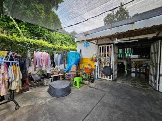 Covered outdoor area with laundry and various items