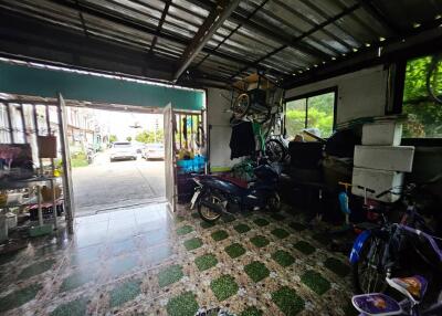 Garage with motorbikes, storage, and outdoor access