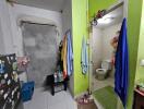 Entrance to bathroom in an apartment showing towels and a small hallway