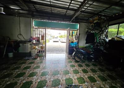 View of a garage with vehicles and storage items